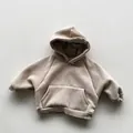 Detail view of khaki fleece hoodie for kids with kangaroo pocket and ribbed cuffs - Apricot / 80cm
