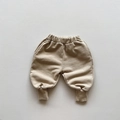 Detail of light beige cotton joggers for kids with elastic waistband and ribbed cuffs - 80cm / Milk Tea
