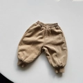 Detailed macro view of khaki fleece-lined corduroy pants with elastic waist and ribbed cuffs - Khaki / 80cm