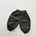 Flat lay of olive green cotton kids joggers featuring elastic waist and ribbed cuffs - 80cm / Dark Gray