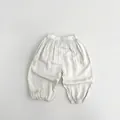 Gros plan sur le pantalon bouffant enfant en coton léger avec taille élastique - 80cm / Abricot Beige