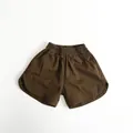 Close-up of vintage brown cotton shorts featuring elastic waist and curved hems - 80cm / Dark Coffee