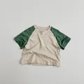 Close-up of kids raglan t-shirt showing breathable cotton slub fabric texture - Khaki/Green