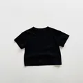 Detailed view of kids minimalist black cotton t-shirt showing basic crew neck design - 80cm / Black