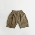 Detail view of coffee-brown cotton linen kids cargo shorts with elastic waist and pockets - 80cm / Khaki