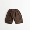 Detailed view of brown cotton-linen kids cargo shorts with elastic waist and side pockets - 80cm / Dark Coffee