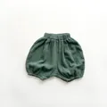 Detail of dark green muslin baby bloomer shorts with natural wrinkled texture - 80cm / Dark Green