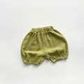 Detail of olive green cotton muslin baby bloomers with elastic waist and soft texture - 80cm / Fruit Green