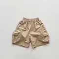 Flat lay of khaki cotton cargo shorts featuring drawstring waist and side utility pockets - 80cm / Khaki