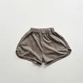 Detail of taupe bamboo cotton kids shorts featuring elastic high waist and side slits - Grey Khaki / 80cm
