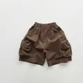 Brown cotton cargo shorts for kids featuring elastic waist and large side flap pockets - 80cm / Dark Coffee