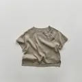 Detail of linen cotton kids shirt with three side buttons and minimalist split hem - 80cm / Brown