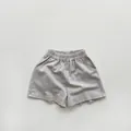 Detailed texture of khaki cotton kids shorts with elastic high waist and side pockets - 80cm / Light Gray