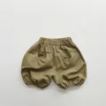 Detailed flat lay of olive green cotton linen kids bloomers with elastic waist and pockets - 80cm / Pine Tea