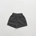 Flat lay detail of kids summer shorts with black and white texture and elastic waistband - 80cm / Polka Dot