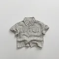 Detail view of cotton striped shirt showing vintage texture and flap chest pockets - 80cm / Apricot