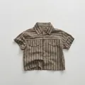 Flat lay of a striped cotton kid's shirt with retro collar and dual chest pockets - 80cm / Brown