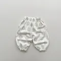 Detailansicht der leichten weißen Kinderhose mit Blattmuster und elastischen Bündchen - 80cm / Beige Aprikose