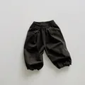Detail view of elastic waistband and gathered hem on kids loose cargo lantern pants - Charcoal Grey / 80cm