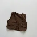 Detail view of brown cotton canvas kids vest with three pockets and button closure - 80cm / Brown