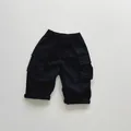 Close-up of black kids cargo shorts with elastic waist and large side flap pockets - 80cm / Black