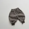 Detail view of boys' striped cotton jogger pants with elastic waist and ribbed cuffs - 80cm / Brown