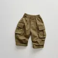 Detail of kids cargo pants with elastic waistband and large flap utility pockets - 80cm / Olive Green