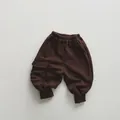 Detail of dark brown kids cargo sweatpants with elastic waist and side flap pocket - 80 / Dark Coffee