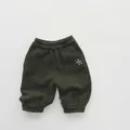 Detail of children's fleece jogger with white star embroidery and elastic waistband - 80cm / Army Green
