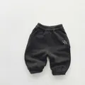 Detail of dark grey kids joggers featuring elastic waist and star print decoration - 80cm / Dark Gray