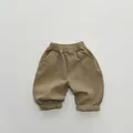 Close-up of children's khaki fleece trousers with elastic waist and large curved pockets - 80cm / Dark Khaki