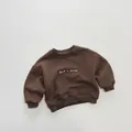 Close-up of brown kid's fleece sweatshirt featuring Dad < mom print and ribbed cuffs - 80cm / Brown