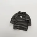 Detail view of children's fleece striped sweater showing soft fabric and chest patch - 80cm / Green Coffee Stripes