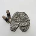 Detailansicht der beigefarbenen Kleinkinder-Winterhose mit geometrischem Gittermuster - 80cm / Beige Schwarz