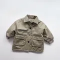 Detailed close-up of army green kids padded coat featuring lapel and large flap pockets - 80cm / Khaki