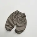 Detail of kids casual knit joggers showing elastic waistband and two back patch pockets - 80cm / Dark Khaki