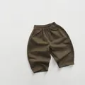 Detail of kids cotton casual pants featuring elastic waist and knee stitching accents - 80 / Tea Brown