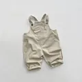 Detail of light khaki cotton overalls showing chest pocket and adjustable button straps - Light Khaki / 80cm