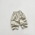 Detail of children's beige cargo shorts with elastic waist and large flap pockets - Khaki / 80cm