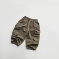 Close-up of olive green cargo shorts for kids with elastic waist and large side pockets - Dark Brown / 80cm