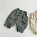 Detail of kids casual loose pants featuring elastic waist and large side pockets - 80cm / Vintage Green