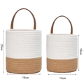 Detail of two-tone cotton woven hanging baskets with brown leather handles in two sizes - Small / Beige & Yellow Patchwork
