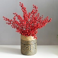 Handmade woven grass vase featuring vibrant red artificial berries for home decoration - Small Patterned Basket And Red Berry Branches