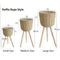 Three sizes of raffia woven floor planters with wooden legs in 34cm, 42cm, 54cm heights - Raffia Beige Small Medium Large