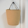 Hanging woven wall planter basket in light brown with black leather handle on white wall - Large / Natural Jute Color