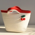 Close-up of cotton woven tote bag with red handles and crochet cherry decorations - White Red Cherry