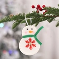 Felt snowman Christmas ornament with green scarf and red snowflake embroidery hanging on tree - Christmas Green Scarf Snowman