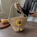 Vintage straw bucket bag featuring a yellow sunflower and colorful woven charms - Sunflower Decor Khaki