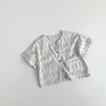 Detail of children striped cotton shirt with round collar and two front square pockets - 80 / Apricot