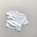 Macro shot of cotton fabric texture and front pocket detail on white short sleeve kids T-shirt - 80 / White